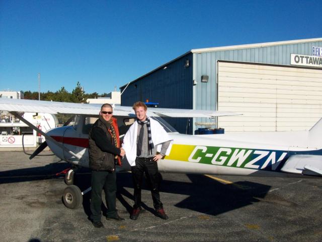 Jamie Scafe after his First Solo: Jamie having already been ceremoniously soaked stands with his instructor Kristian